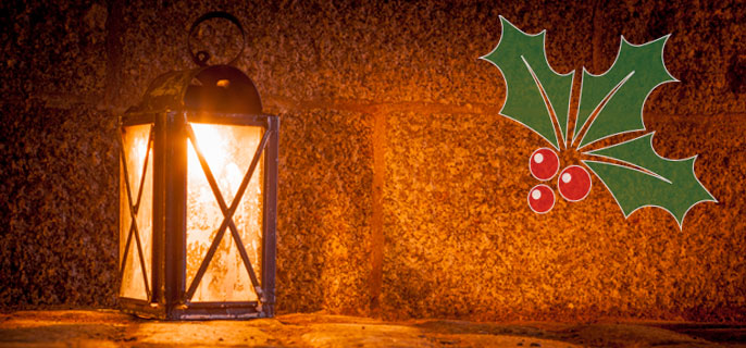A lantern and holly and berries.