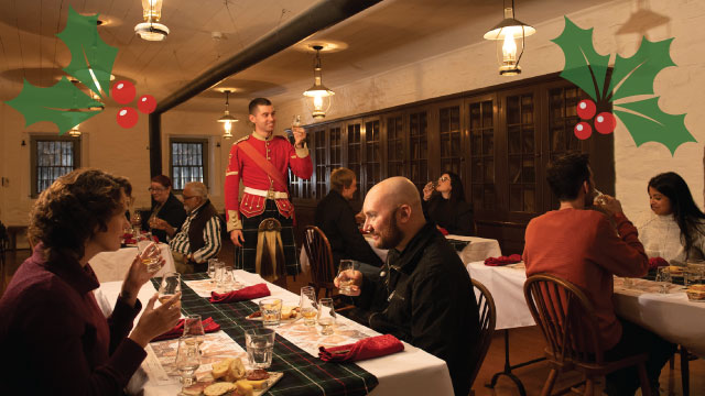 A group sitting at a decorated table raises their glasses for a toast.