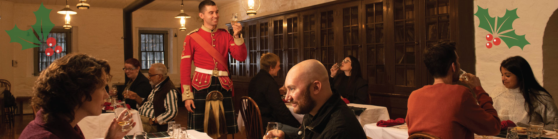 A group sitting at a decorated table raises their glasses for a toast.  