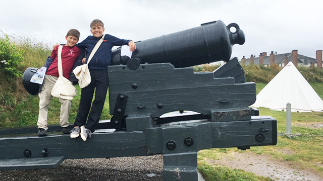 Two young people with the Noon Gun.