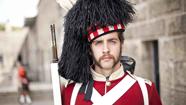 A Highlander wearing a feather bonnet.