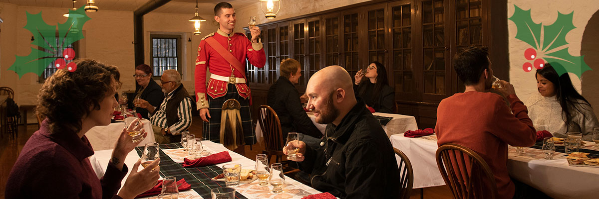 A group sitting at a decorated table raises their glasses for a toast.  