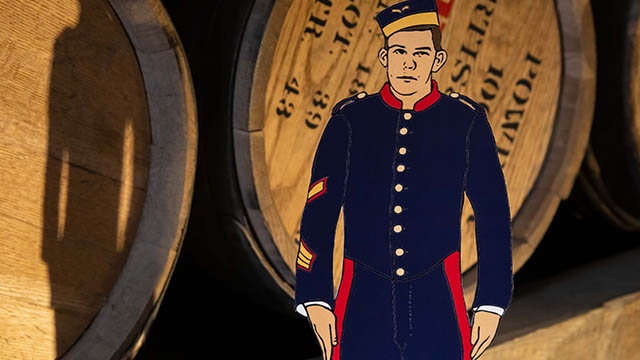 A paper doll soldier posed on the railing at the signal post. Behind him, an interpreter in Royal Artillery uniform secures ropes from the mast.