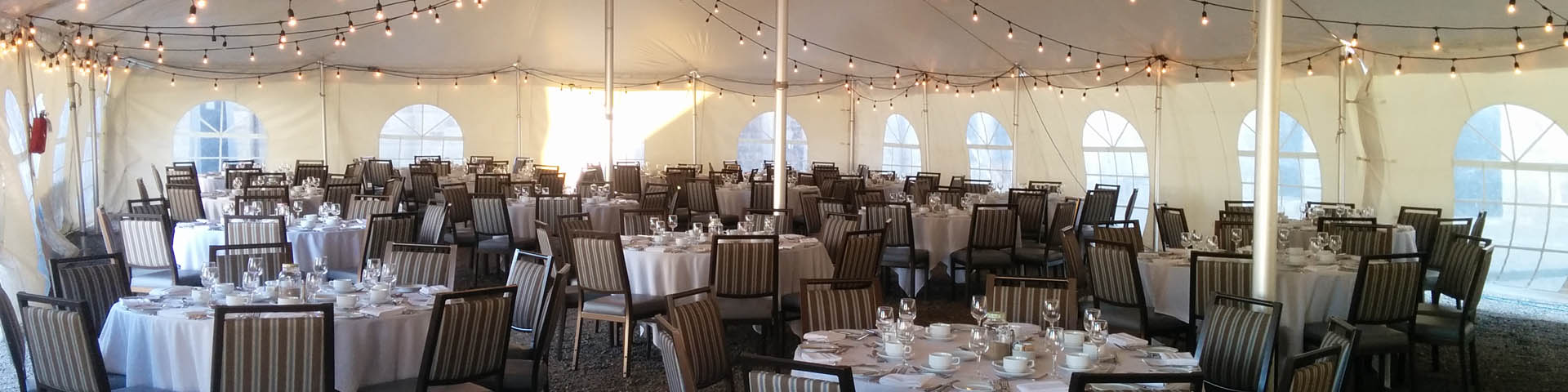 Tables set up under a marquee. 