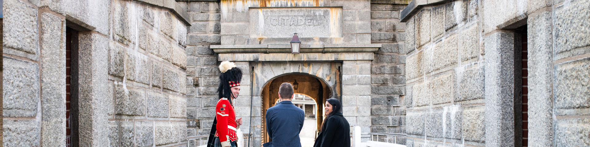 Visitors walk past a 78th Highlander.