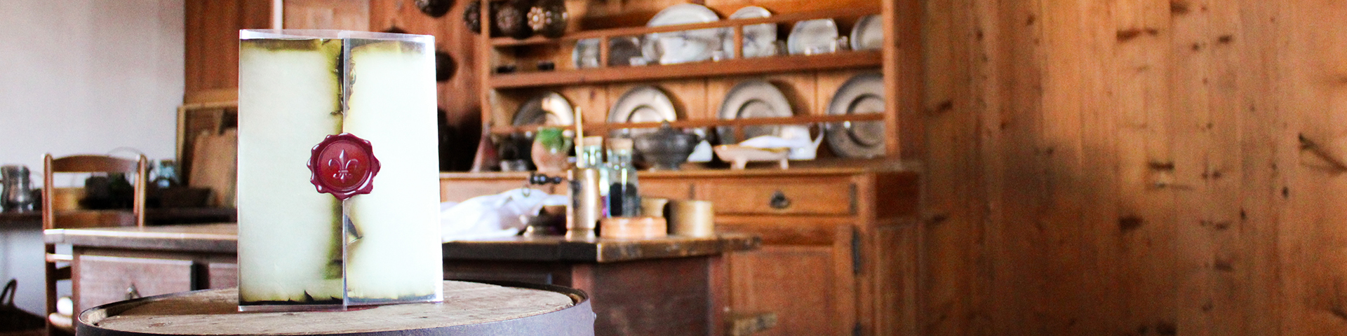 A pamphlet with a red seal sitting on a wooden barrel.