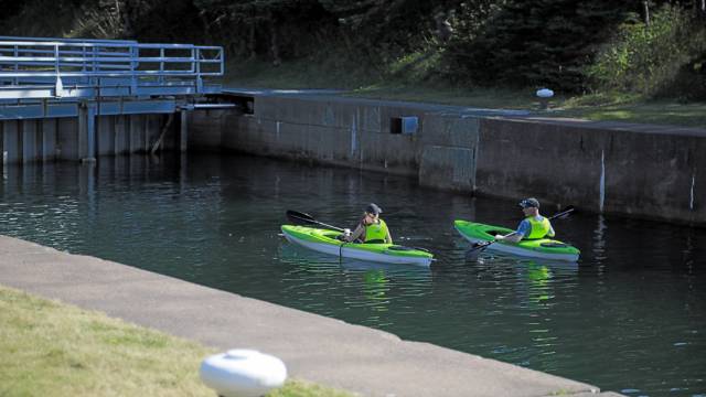 Two kayaks wait for the canal locks to open. 