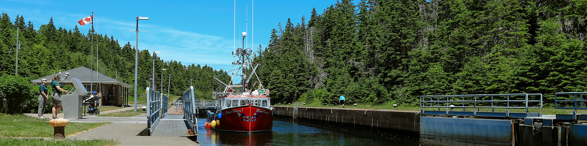 A fishing boat coming through a lock canal.