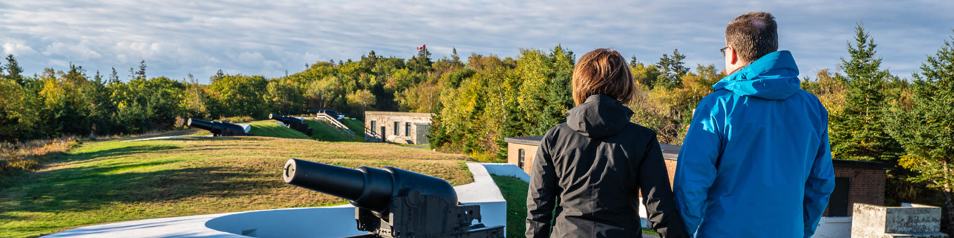 A couple next to a cannon.  