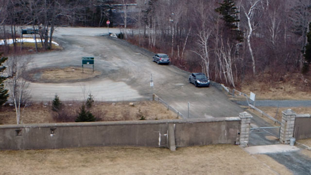 There is limited space to park on the side of the gravel driveway outside the gates.