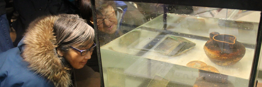 Two people looking at submerged artifacts.