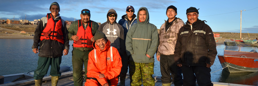 A group of people standing on a dock.