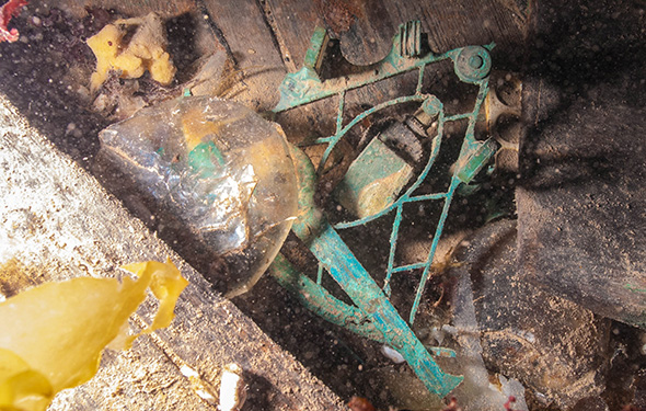 Sextant in the water, surrounded by seaweed