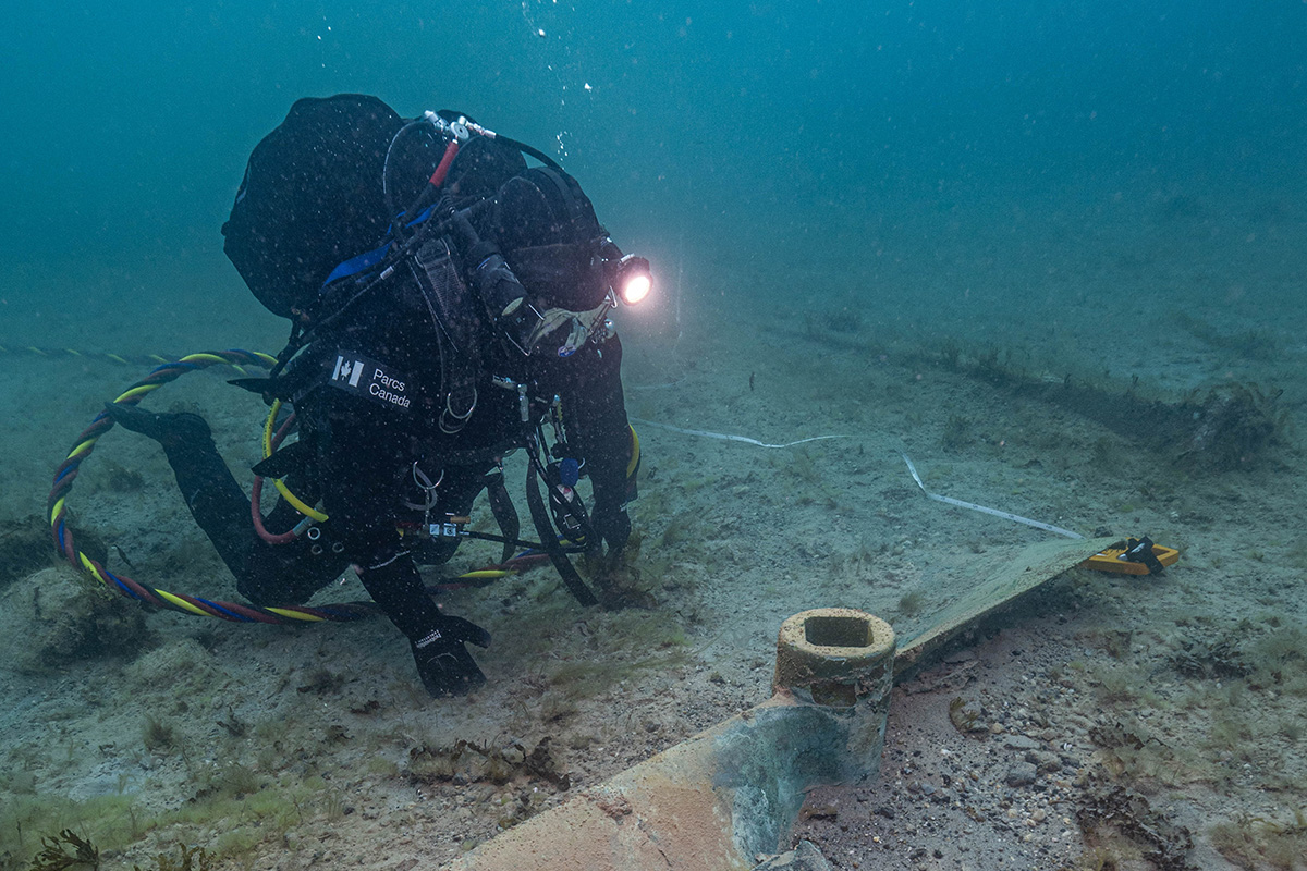Parks Canada underwater archaeology technician Joe Boucher documents one of HMS Erebus’ propellers discovered in 2015 within the debris field surrounding the hull, September 13, 2023.
