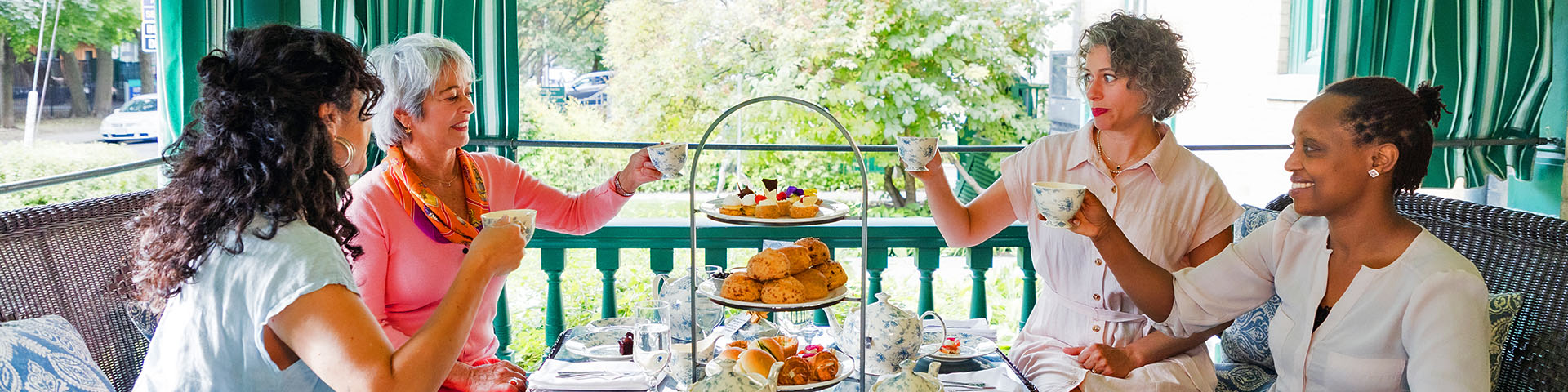 A group enjoying tea on a veranda. 