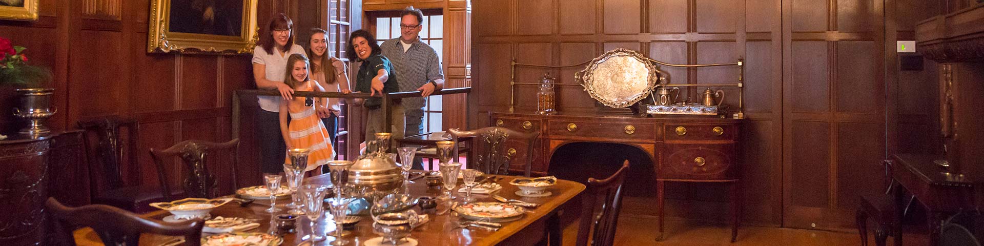 A group is shown around an old room. 