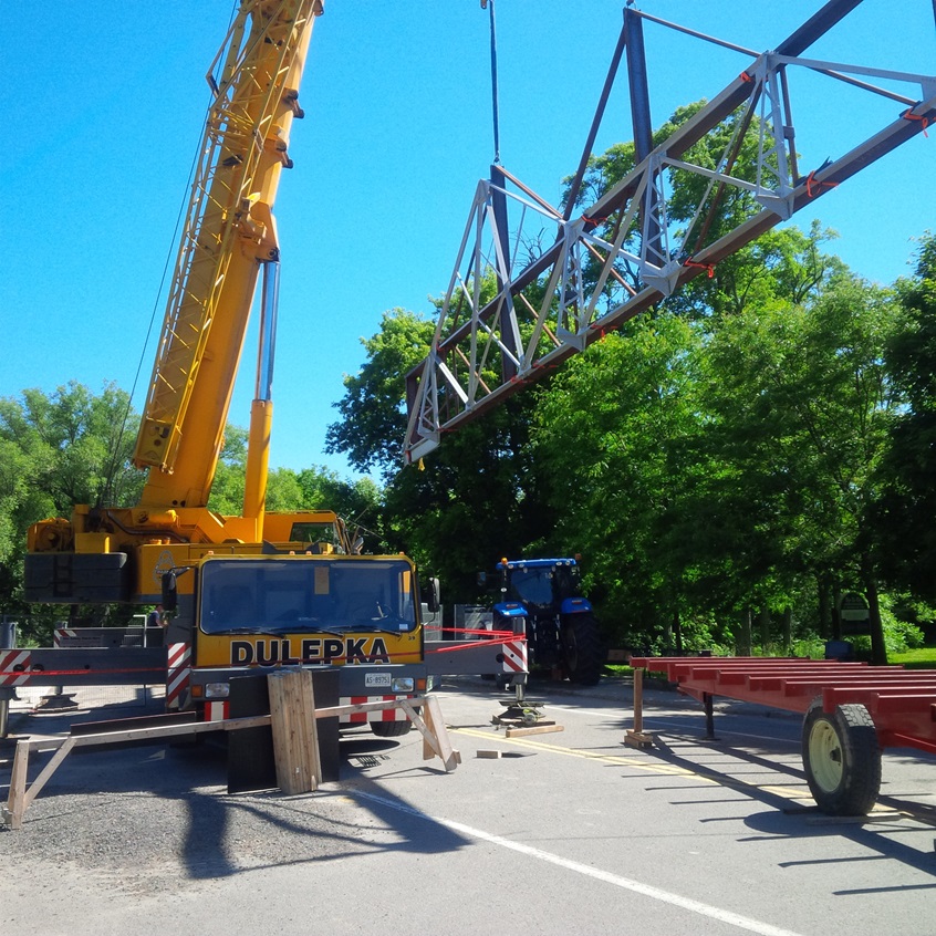 Portion of the newly repaired bridge lifted into place by crane