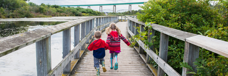 Two children on a boardwalk.