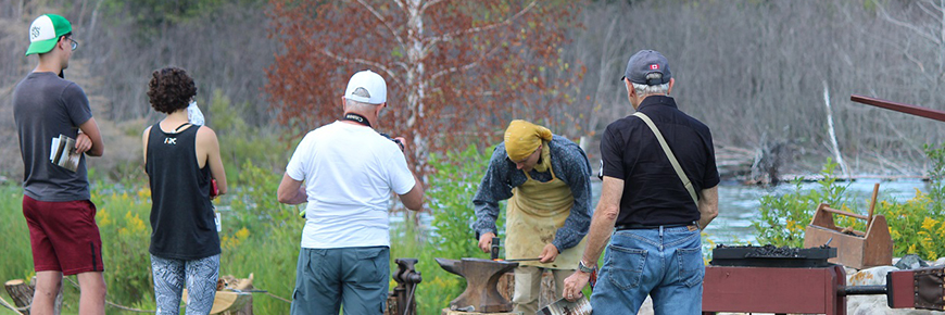 Visitors watching a blacksmith