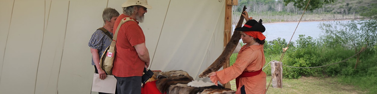 Staff presenting furs to visitors