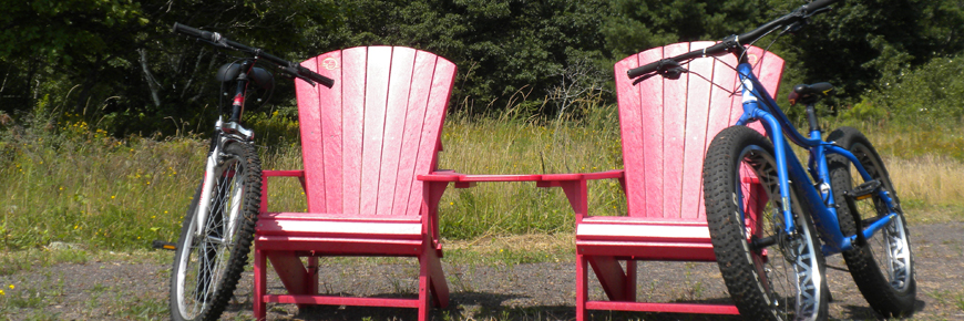 Two bicycles, two red chairs