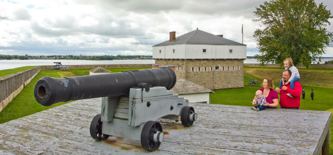 A family viewing a cannon on a raised platform