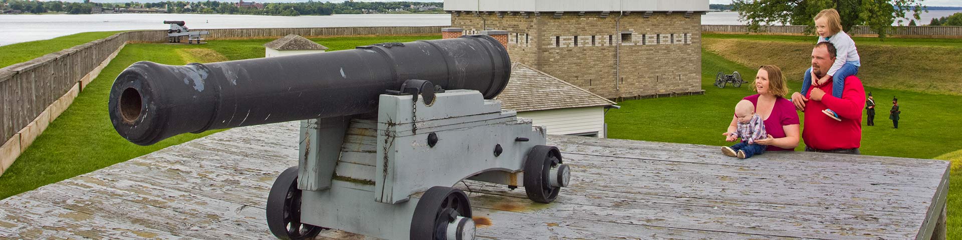 A family standing with a cannon. 