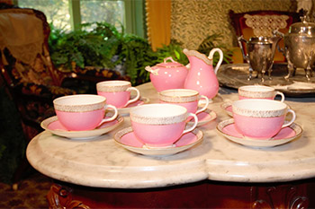 Pink tea set on set table