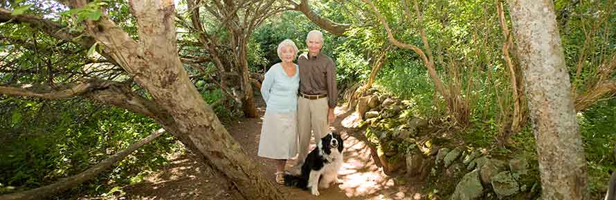A couple and their dog at the Site of LM Montgomery's Cavendish Home
