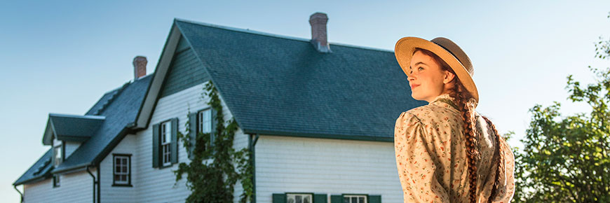 Anne impersonator walking towards Green Gables.