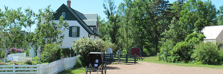 Green Gables Heritage Place on a sunny day, viewed from the north side of the house with a carriage in front of it. 