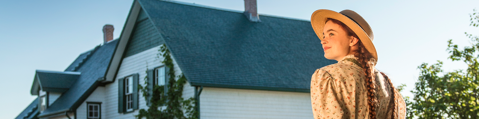 Anne looks towards the sun in front of Green Gables House