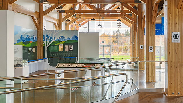 A smooth ramp with railings on either side leads visitors to the interpretive panels at the Green Gables Visitor Information Centre.