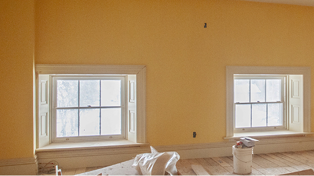 Two windows low to the floor with yellow walls