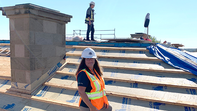 Nicolle Gallant, Project Manager for the Province House conservation project, on site when the roof work was underway. The new roof combines traditional materials with modern day elements ensuring water infiltration won’t be an issue moving forward.