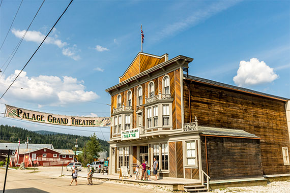 Des visiteurs devant le théâtre Palace Grand au lieu historique national du Complexe-Historique-de-Dawson