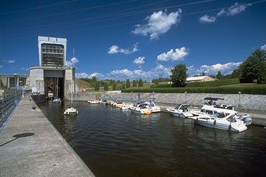Boats leaving the lock and others on the dock awaiting next lockage upstream. To the right, Carillon park.