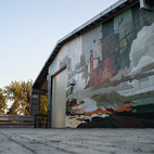 Mural of an industrial landscape painted on a building near the Lachine Canal.