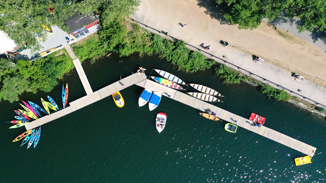 Waterfront dock surrounded by non-motorized boats and kayaks