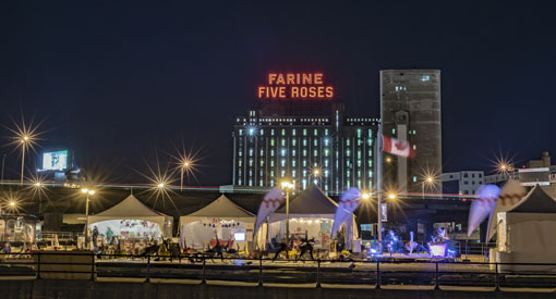 Visitors to the Peel Basin and Farine Five Roses light sign in the background