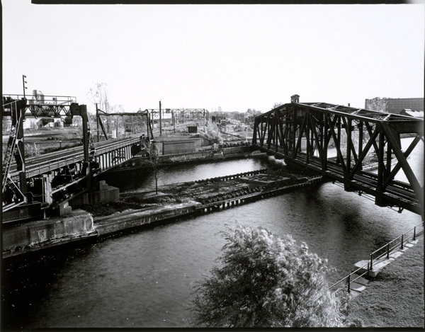 photo aérienne en noir et blanc d'un pont qui traverse un canal