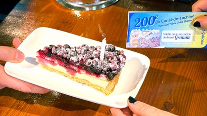 Hands serving a piece of cake.