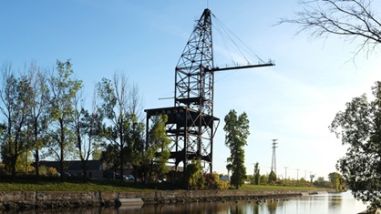 Metal crane on the banks of a canal