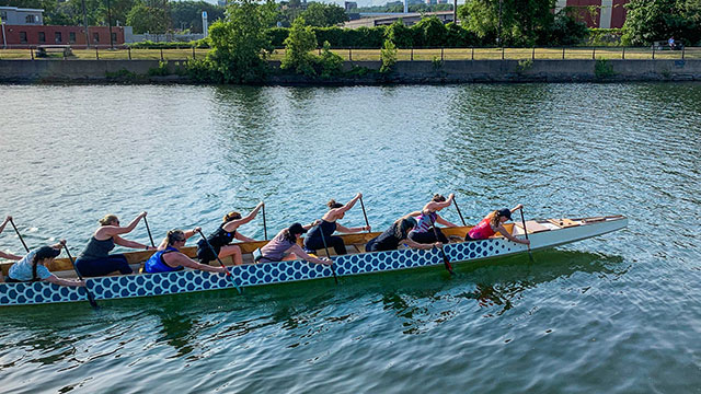 Group of people paddling a dragon boat 
