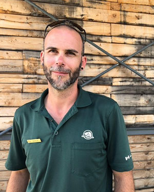 Parks Canada team member, smiling, wearing a green sweater.