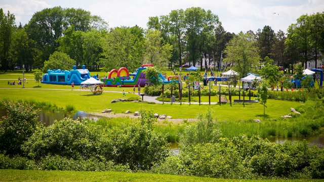 View of all the inflatable games at the Cartier-Brébeuf national historic site during a summer event.
