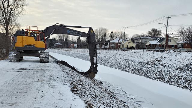 Excavator digging near a watercourse