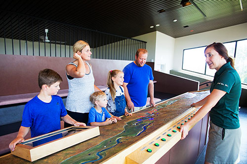 A Parks Canada guide presents to a group the scale model and view from the belvedere.