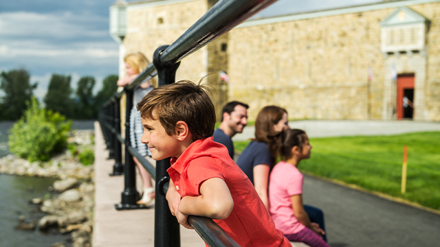 A young boy observes the Richelieu River outside Fort Chambly National Historic Site.