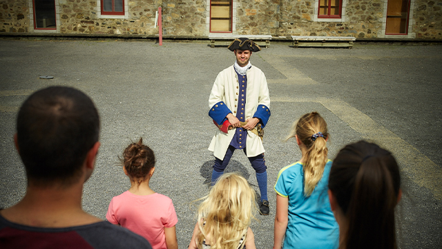 A young boy observes the Richelieu River outside Fort Chambly National Historic Site.